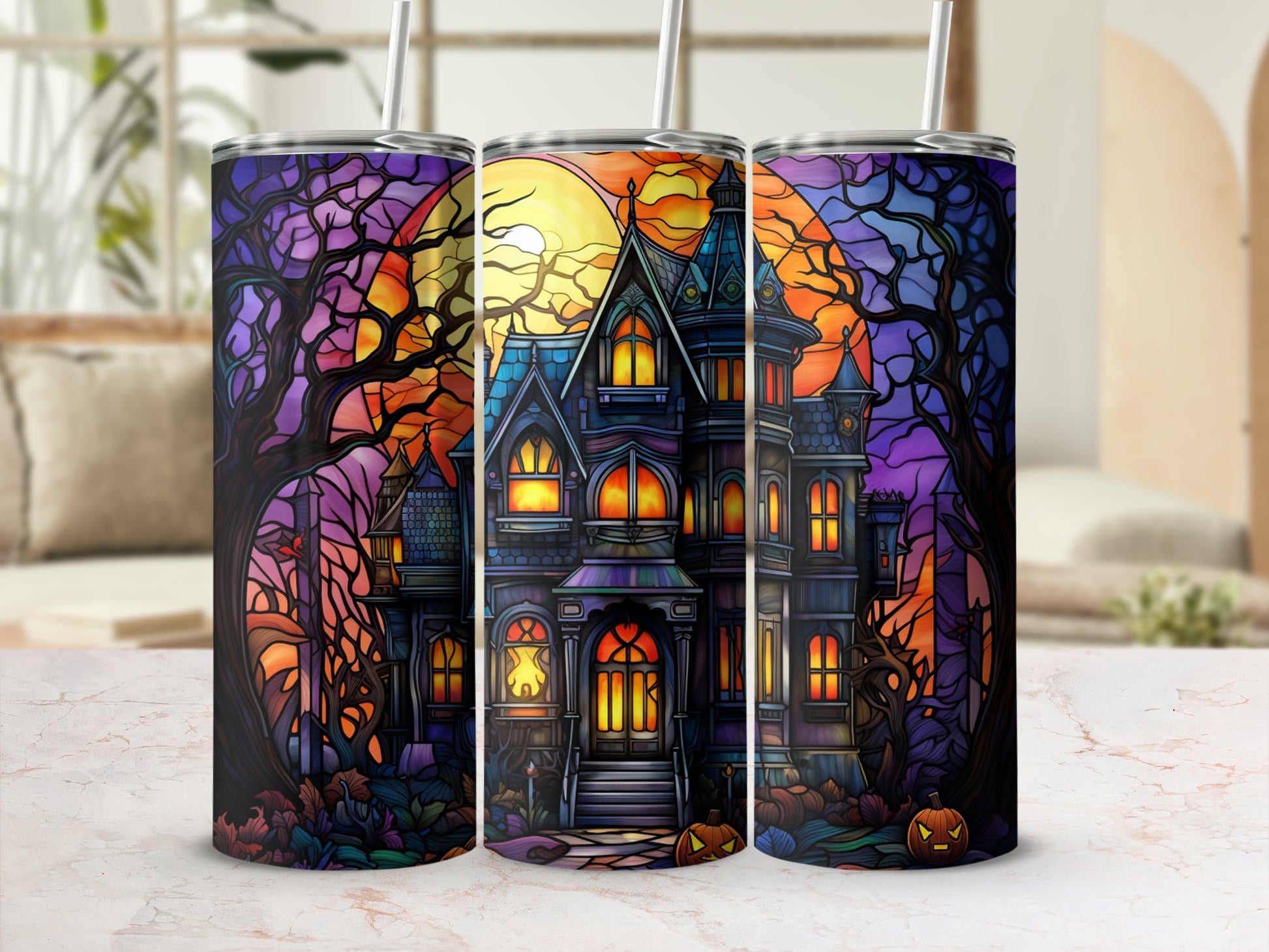 Haunted house with pumpkins and moon on a Halloween tumbler.