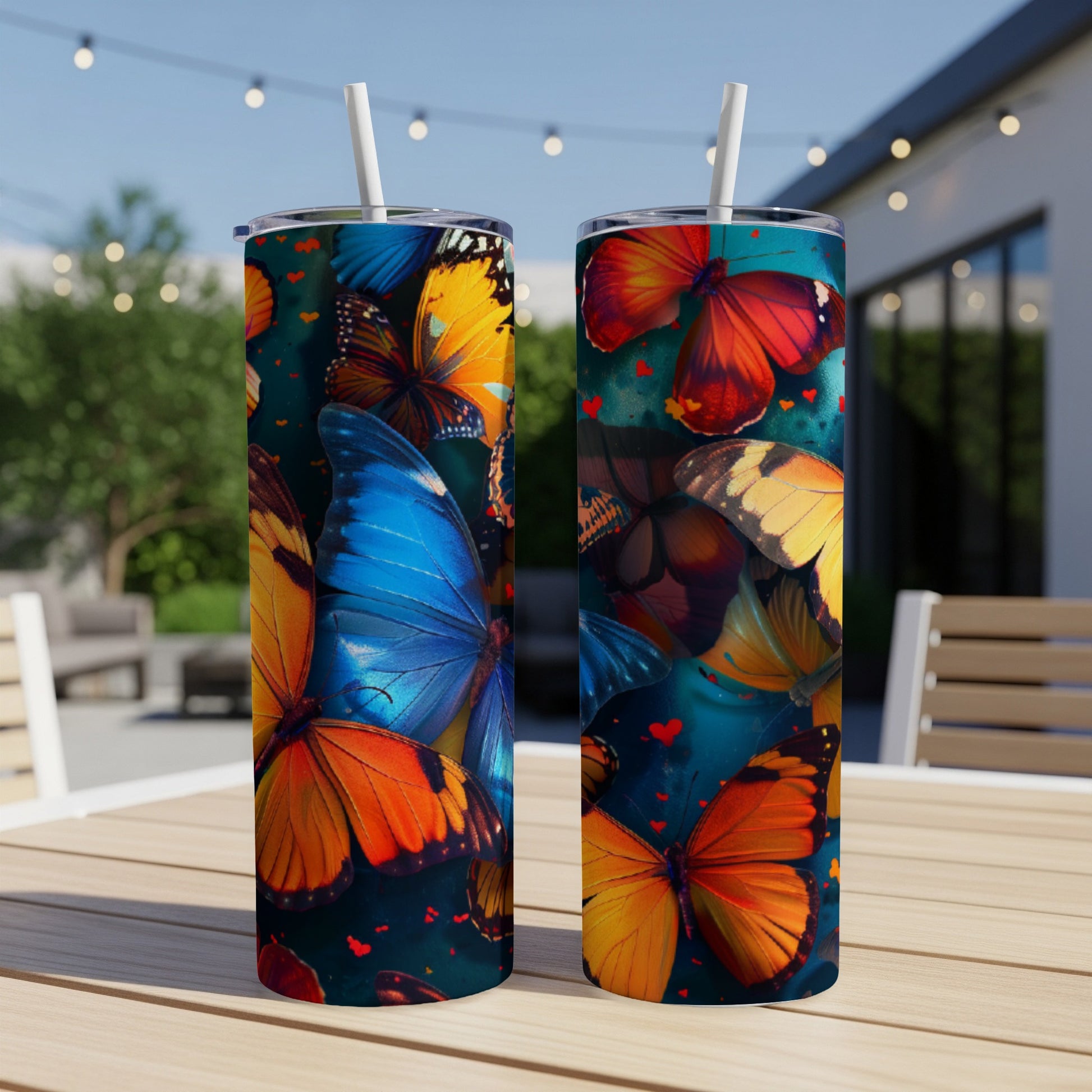 Two tall tumblers with a colorful butterfly and heart pattern.
