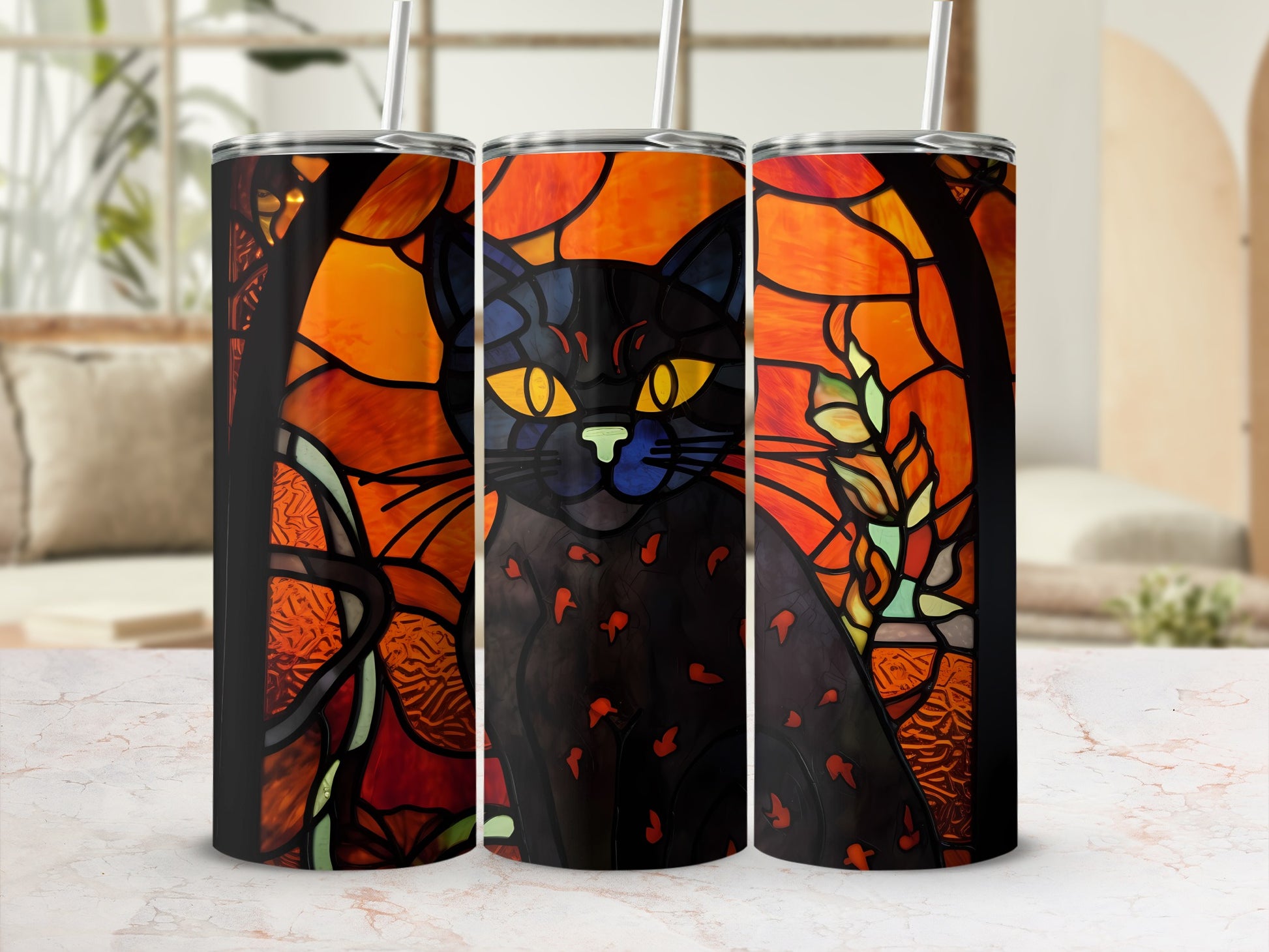 Stained glass black cat art on three tumblers against a blurred background.