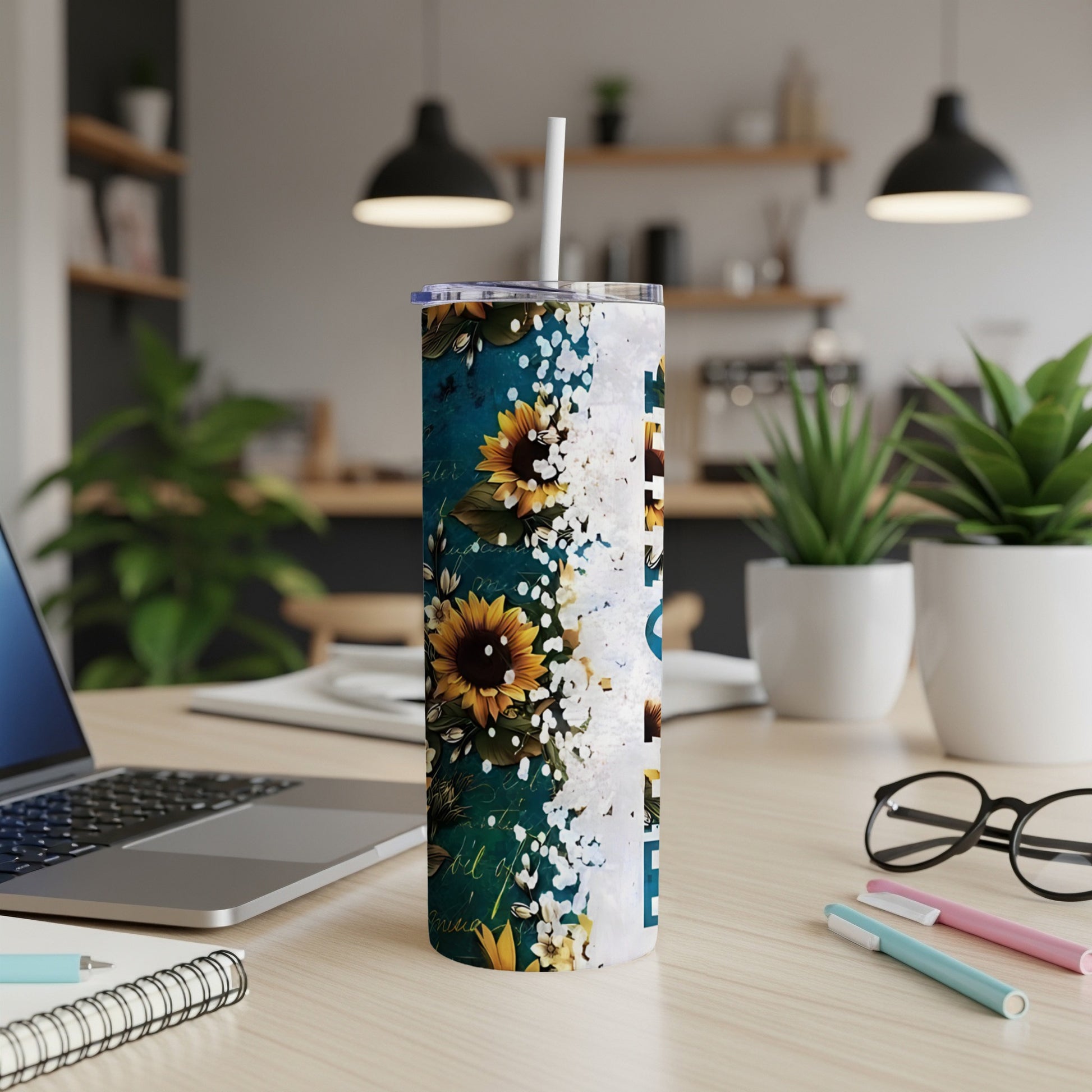 Tall tumbler with sunflowers and abstract white text.