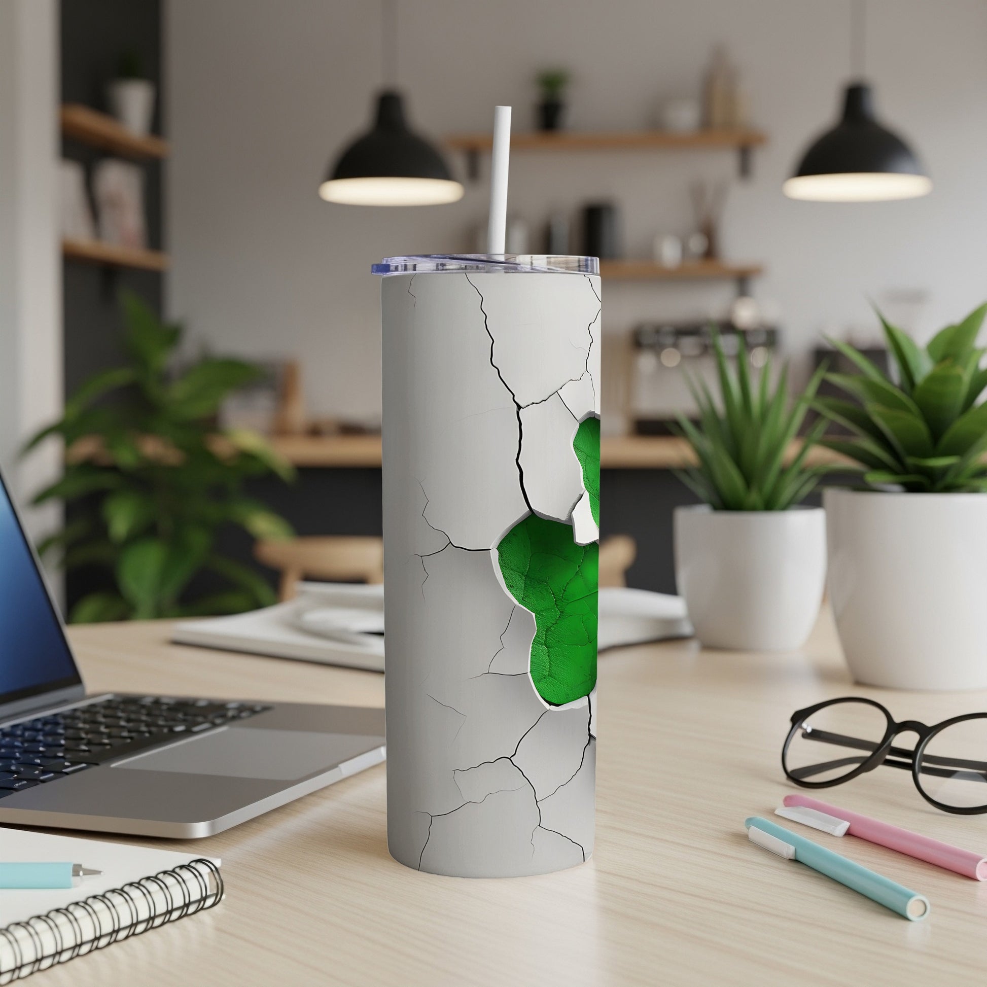 White tumbler with cracked surface revealing a green shamrock design.