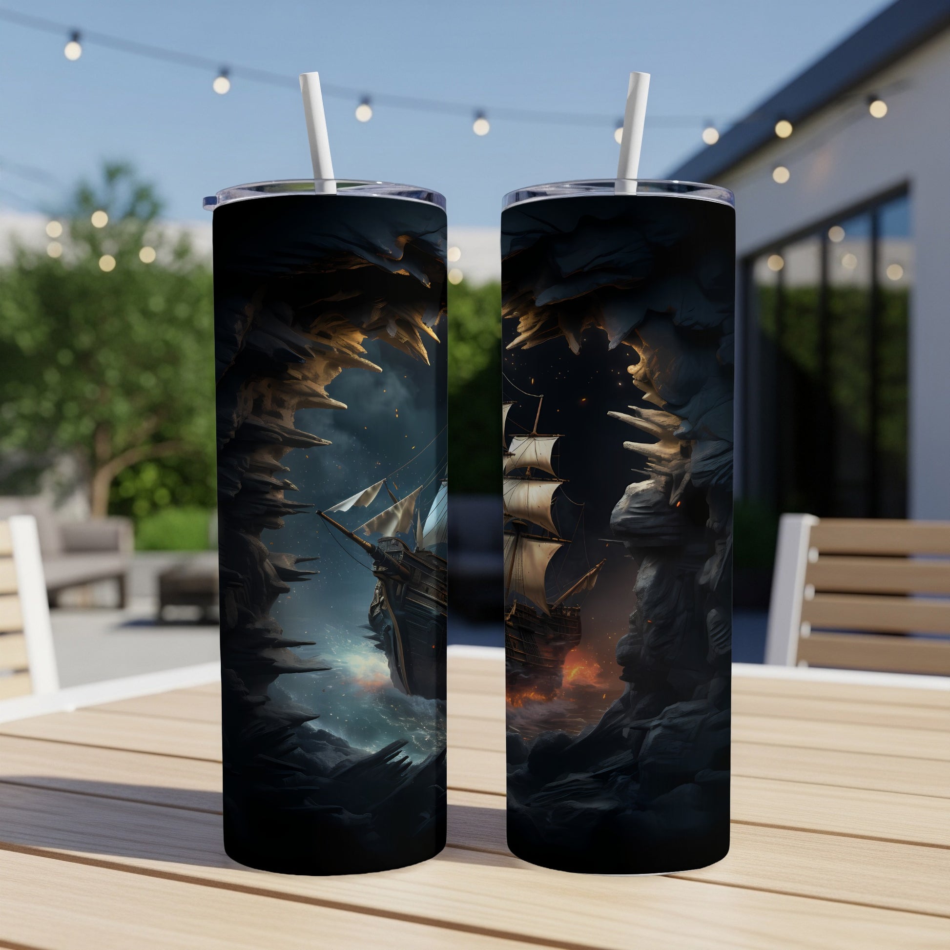 Two tumblers with fantasy art of a pirate ship emerging from a cave.