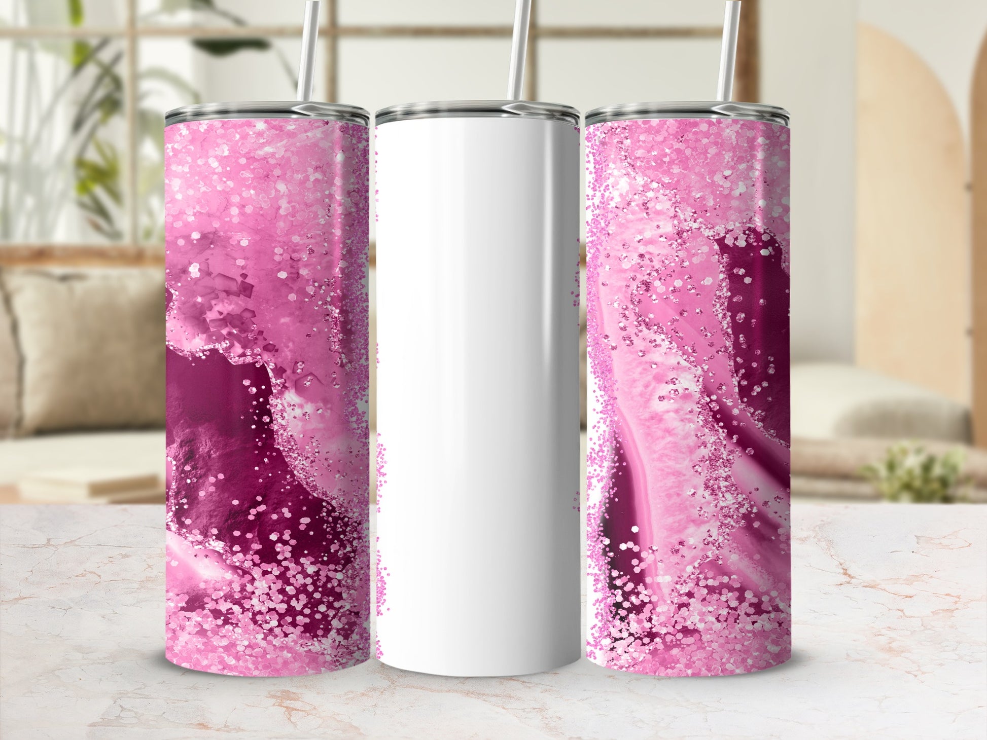 Three tall, skinny tumblers with pink glitter and abstract designs.