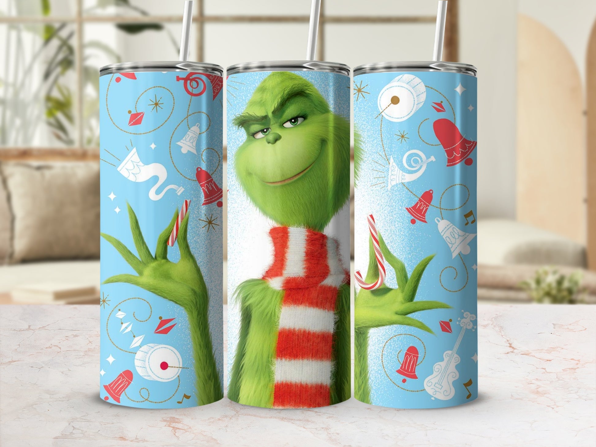 Grinch in striped scarf with Christmas icons on light blue tumbler.