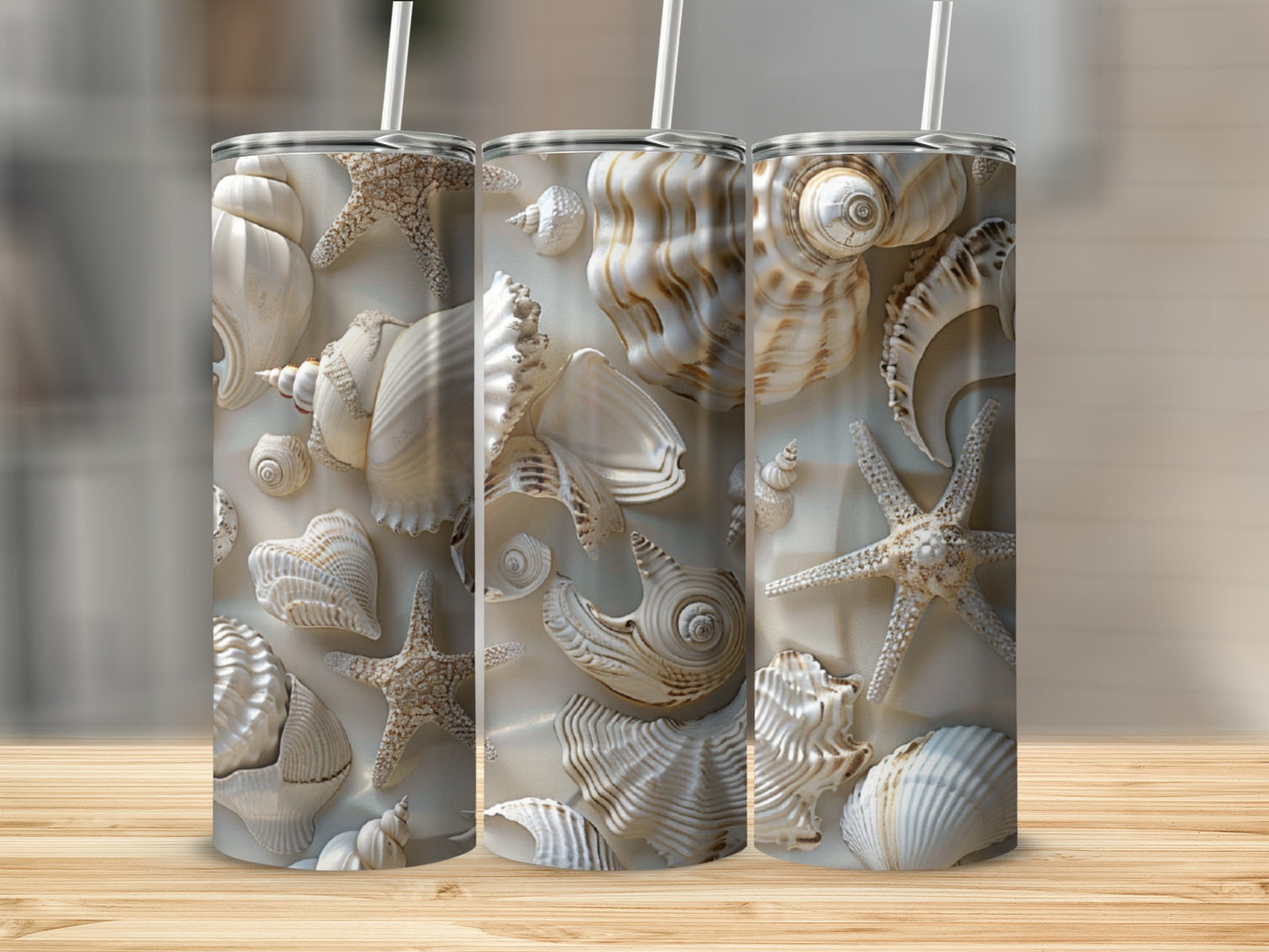 Seashell and starfish pattern on three white tumblers with straws.