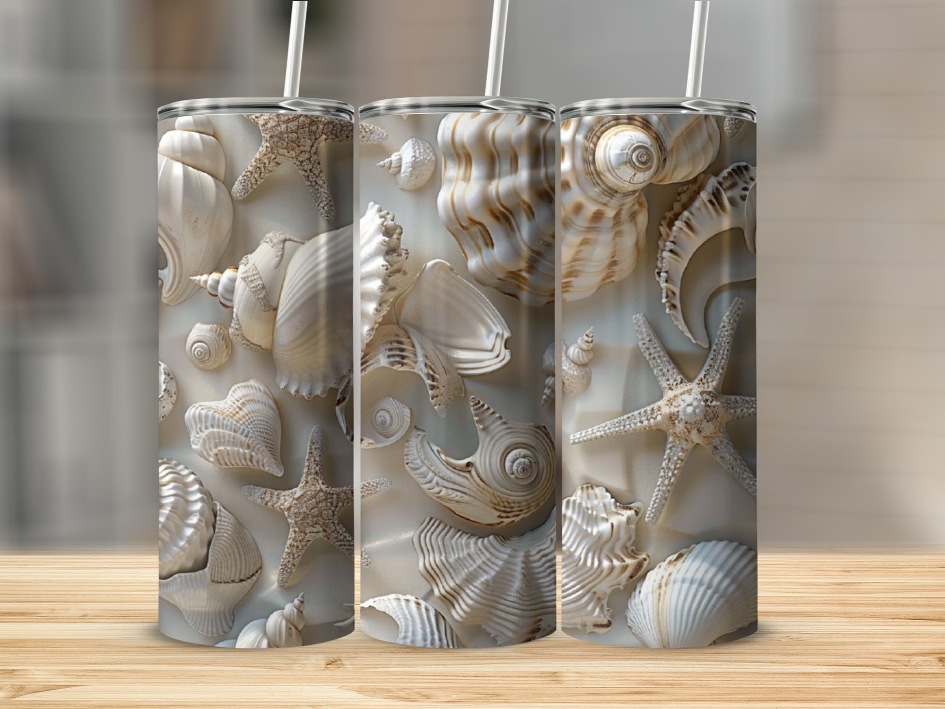 Seashell and starfish pattern on three white tumblers with straws.