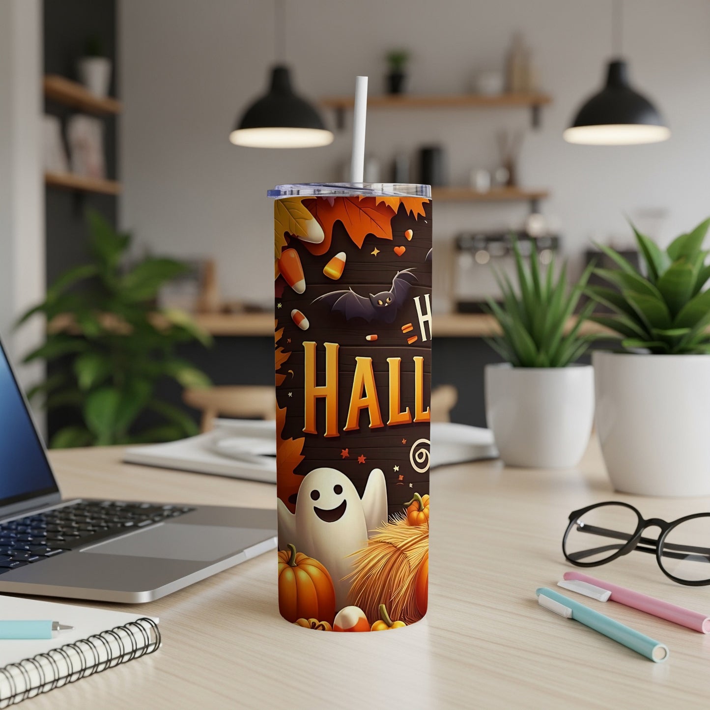 Halloween tumbler with ghost, bat, pumpkins, candy corn, and autumn leaves design.