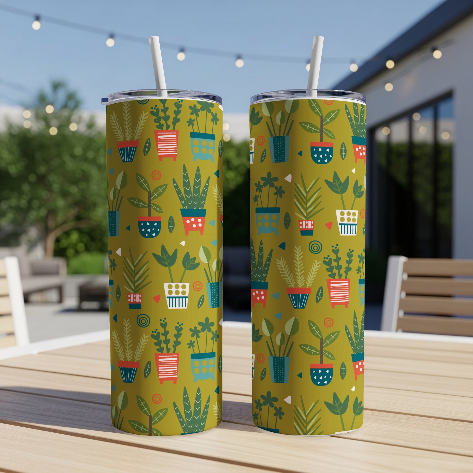 Two tumblers with a green background and a pattern of stylized potted plants.
