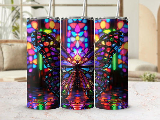Tumbler with stained glass butterfly design on a marble surface.
