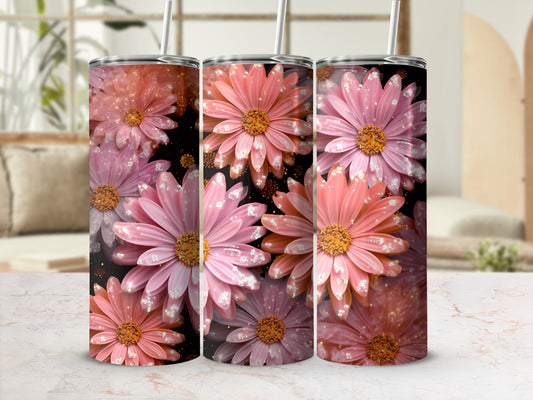 Three tumblers with pink and orange daisy floral design and glitter accents.