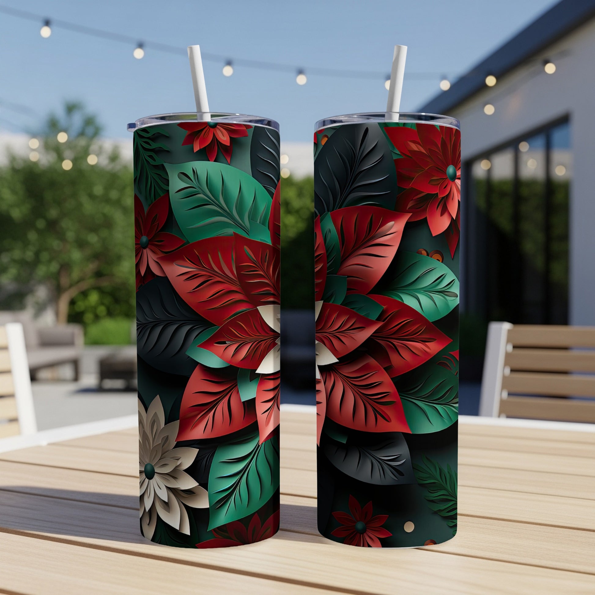 Two tumblers with a red, green, and white floral pattern sit on a table.