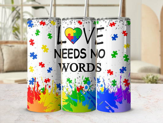Three tumblers with autism awareness puzzle pieces and colorful paint splatters.