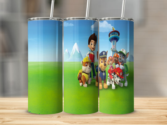 Paw Patrol characters Ryder and pups on grassy field with mountains and sky.