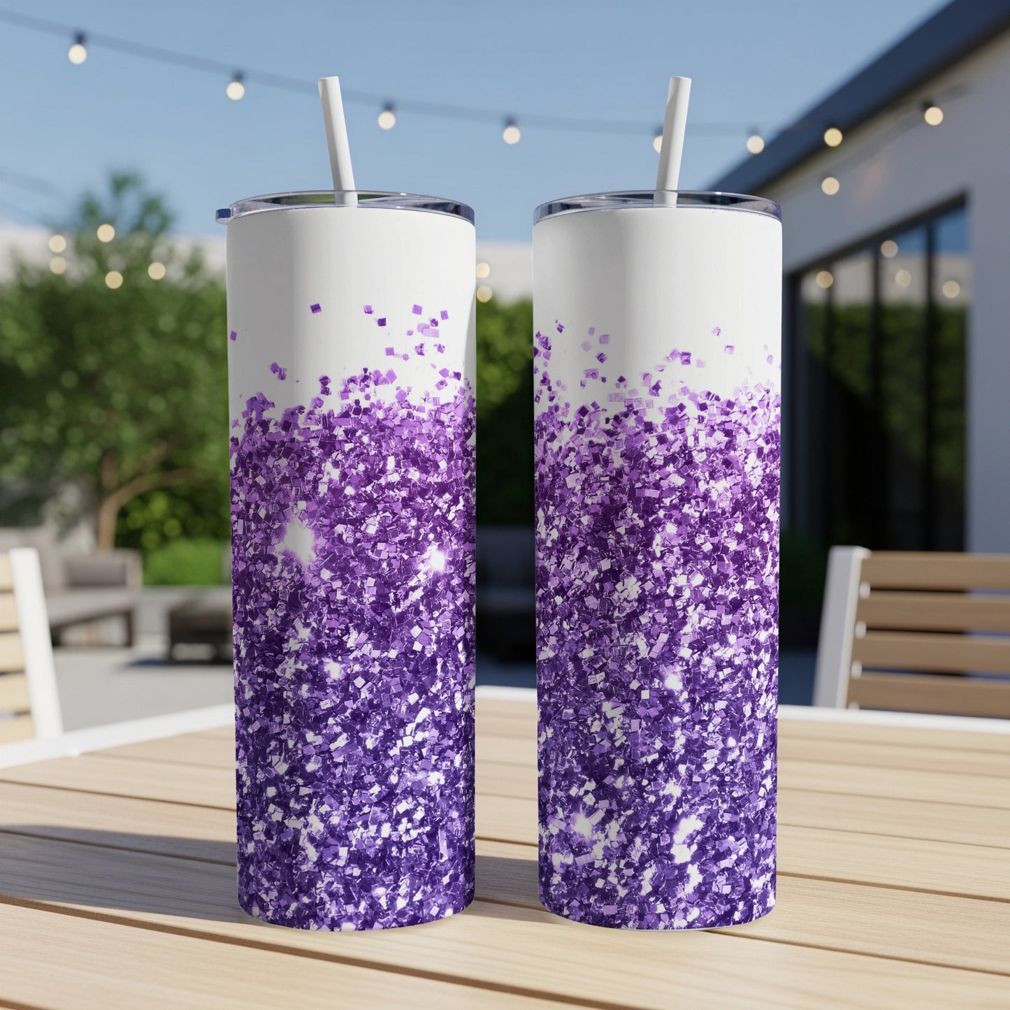 Two glitter-covered tumblers with purple ombre design on a wooden table.