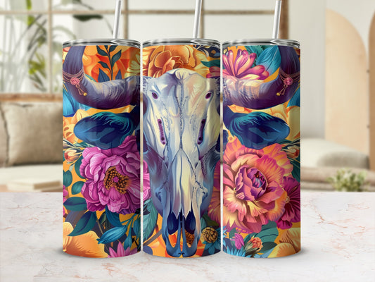 Floral skull tumbler with colorful flowers and ornate horns on a countertop.