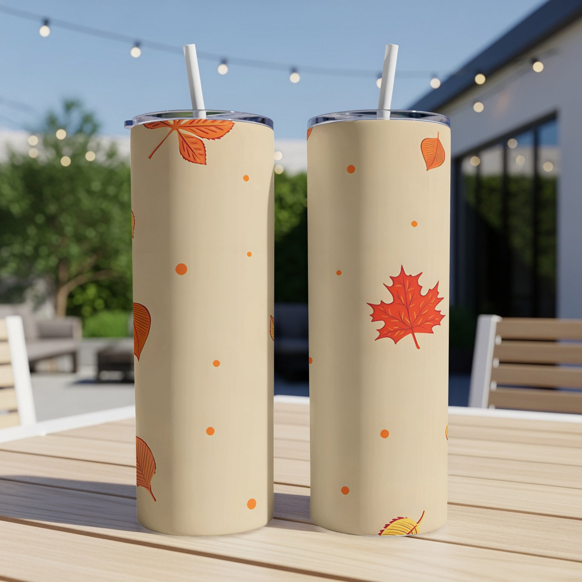 Two tan tumblers with orange autumn leaf and dot pattern.