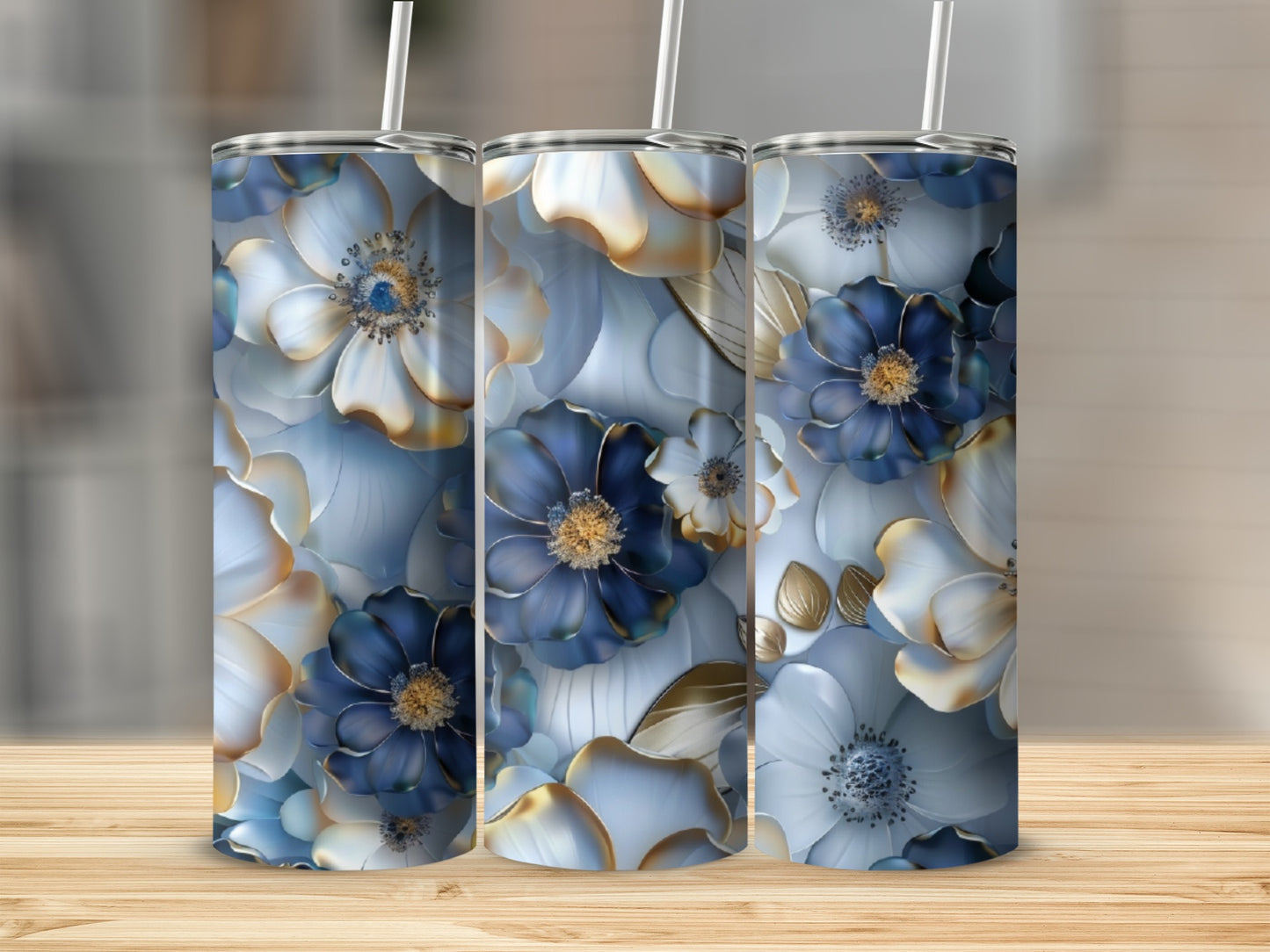 Three tumblers with blue and white floral designs and gold accents.