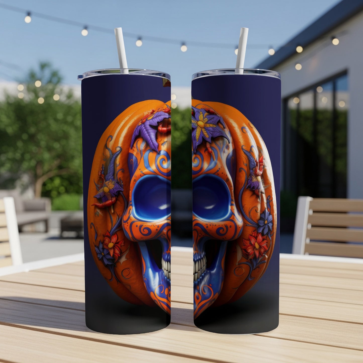 Two tumblers with a split pumpkin and skull design featuring blue and orange floral accents.