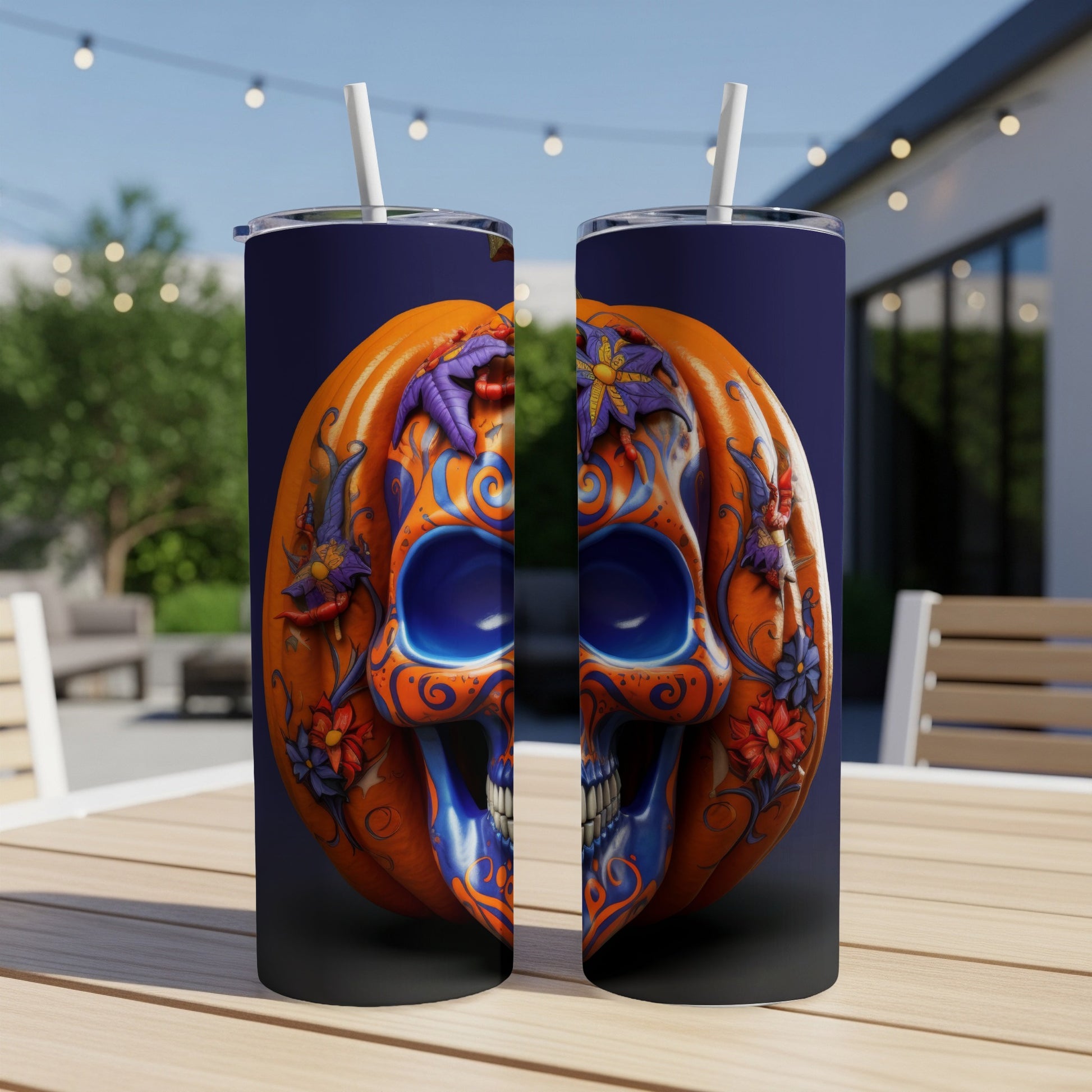 Two tumblers with a split pumpkin and skull design featuring blue and orange floral accents.
