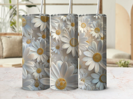 Three tumblers covered in white daisies with yellow centers stand in a line.