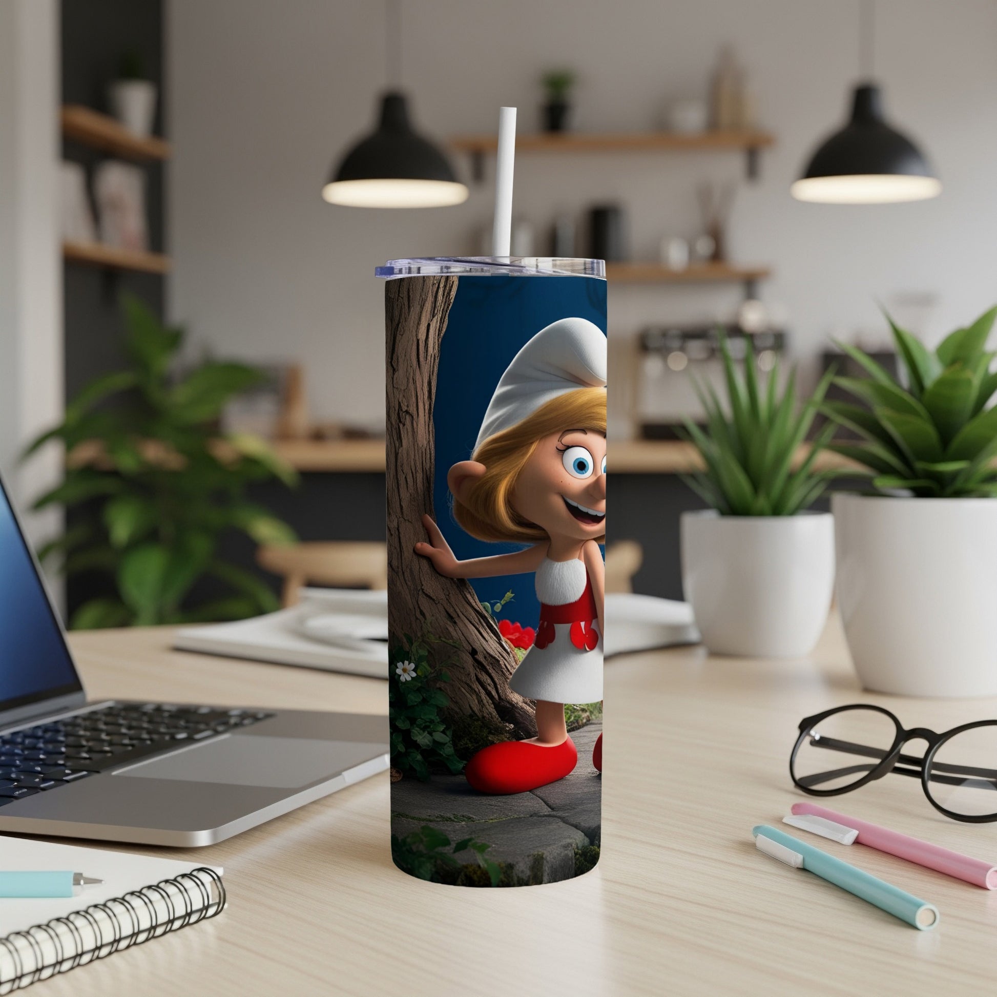 Smurfette character on a white tumbler with a straw on a desk.