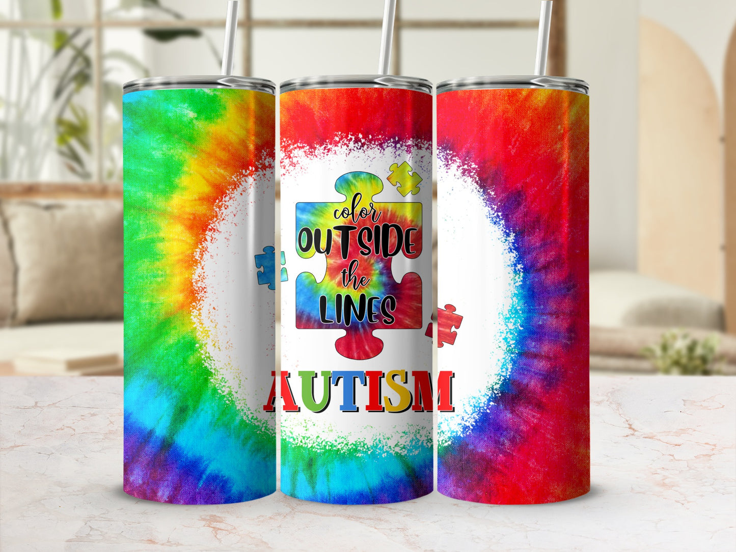 Tie-dye tumbler with "color outside the lines autism" text and puzzle pieces.