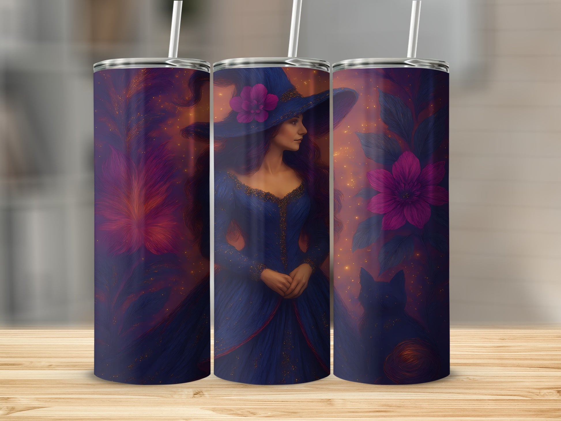Three tumblers with a witch and floral design on a wooden surface.