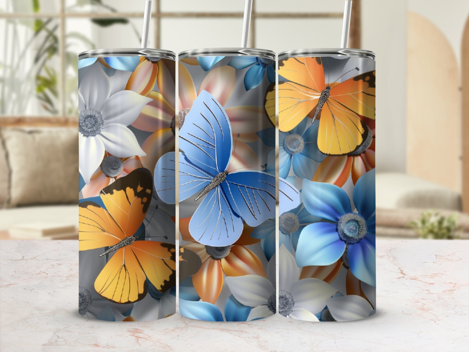 Tumblers with blue, orange, and white flowers and butterflies.
