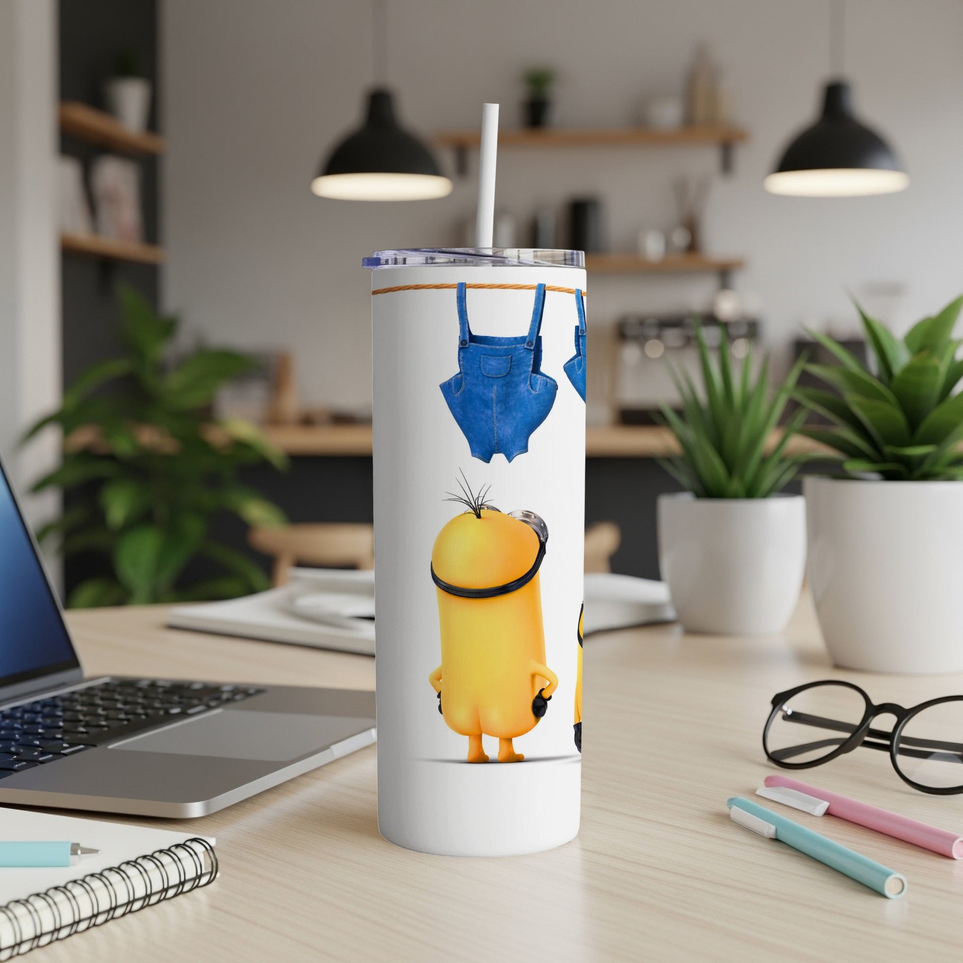 Minions on a white tumbler with denim overalls and a straw.