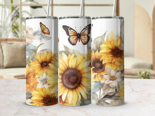 Three tall tumblers with sunflowers and butterflies on a patterned surface.