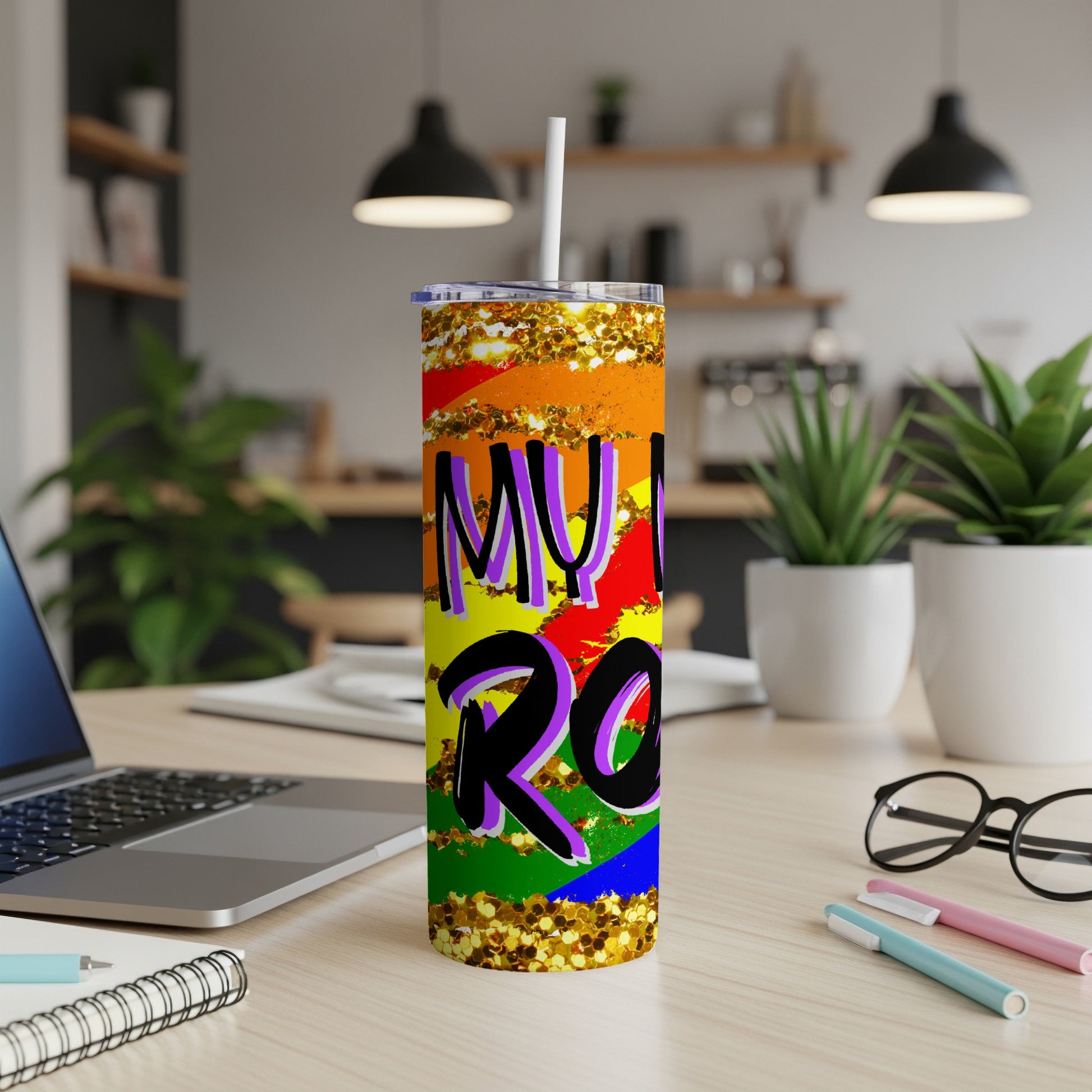 Rainbow glitter tumbler with "MY VIBE IS ROCK" text on a desk.
