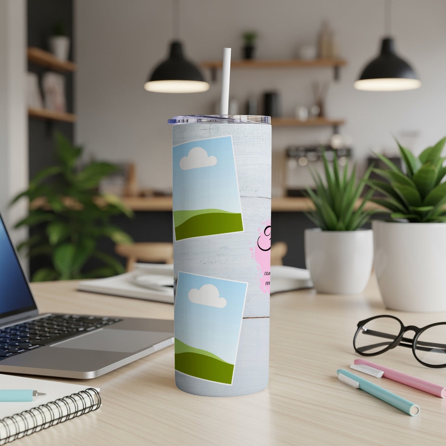 White tumbler with blue wood grain pattern, two framed landscape photos, and pink text.