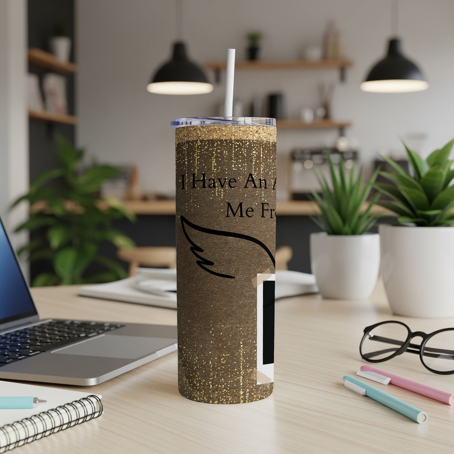 Brown glitter tumbler with text "I Have An Angel Watching Over Me" and wing graphic.