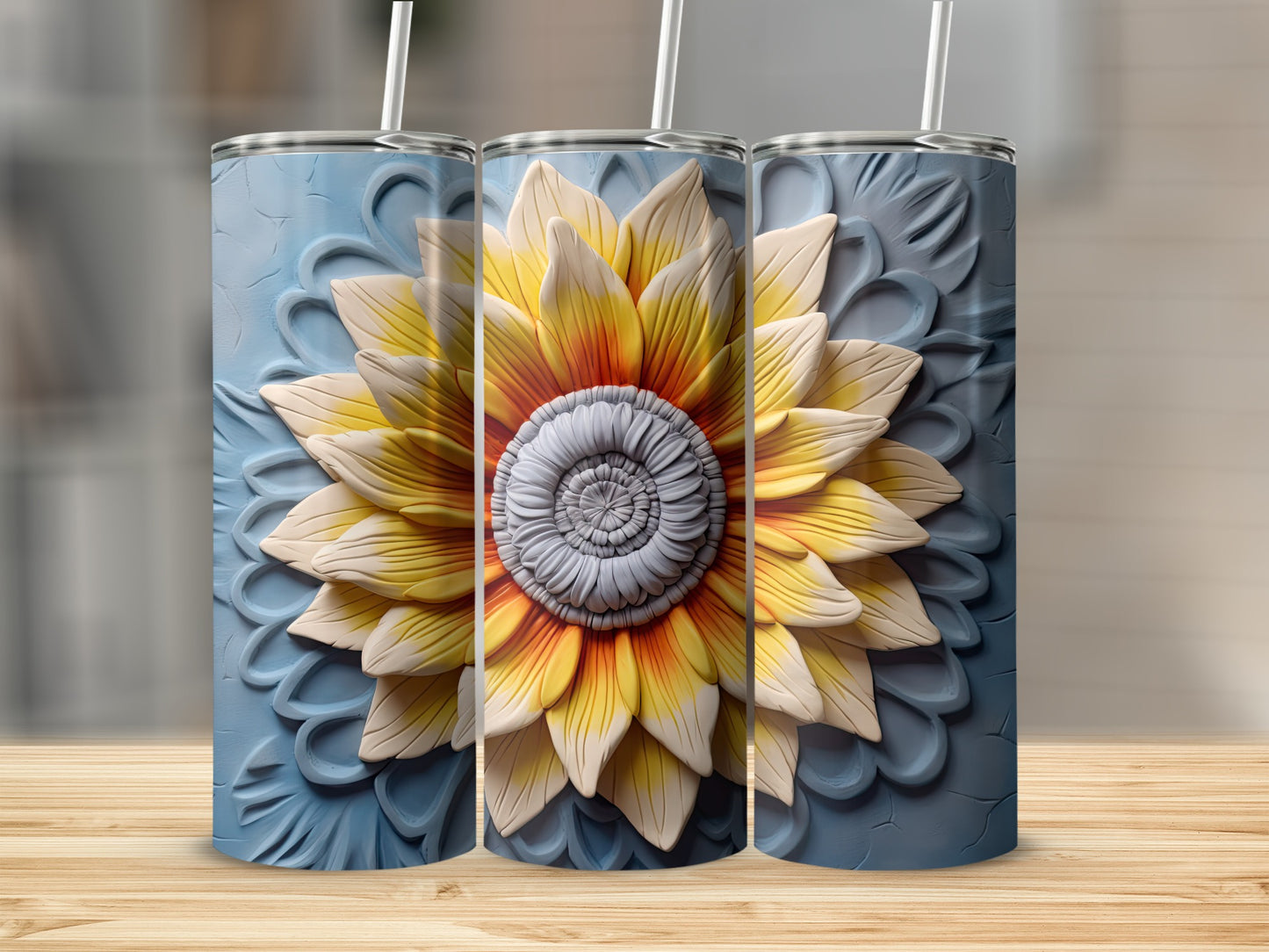 Three tumblers featuring a raised sunflower design on a blue textured background.