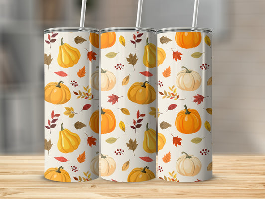 Three tumblers with a fall pumpkin and leaf pattern on a wooden surface.