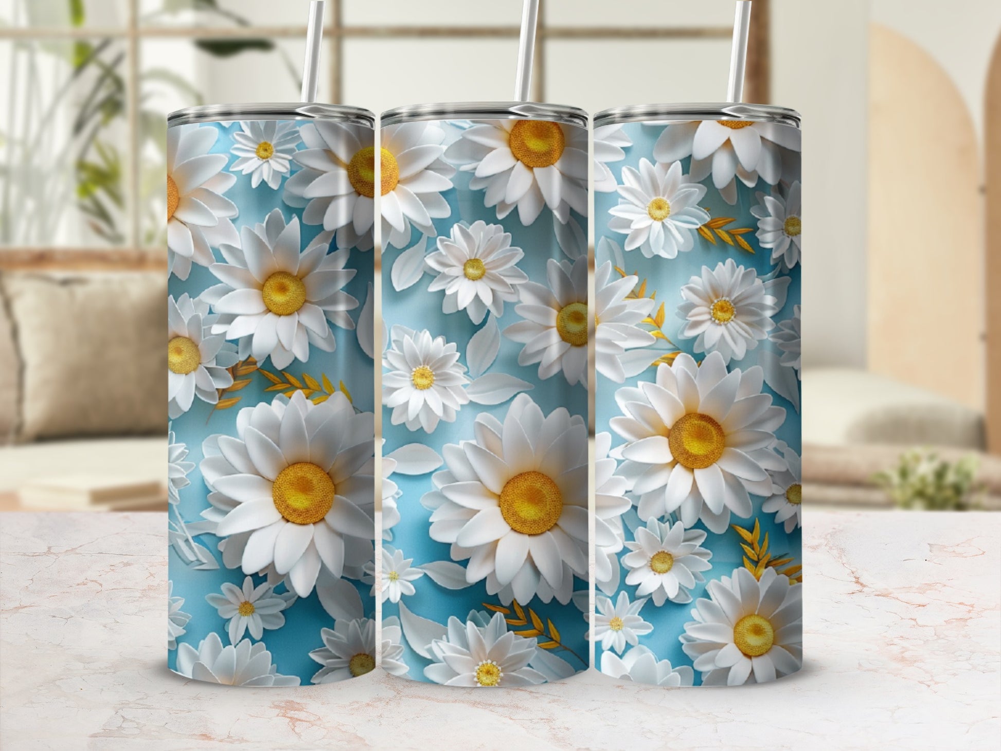 Three tall, slender tumblers adorned with white daisies on a light blue background.