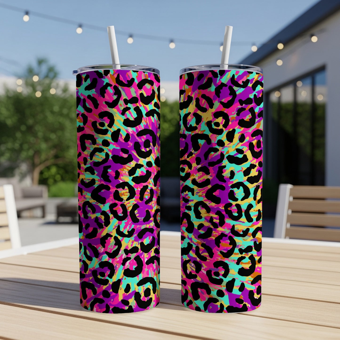 Two tumblers with a vibrant neon leopard print pattern and white straws.