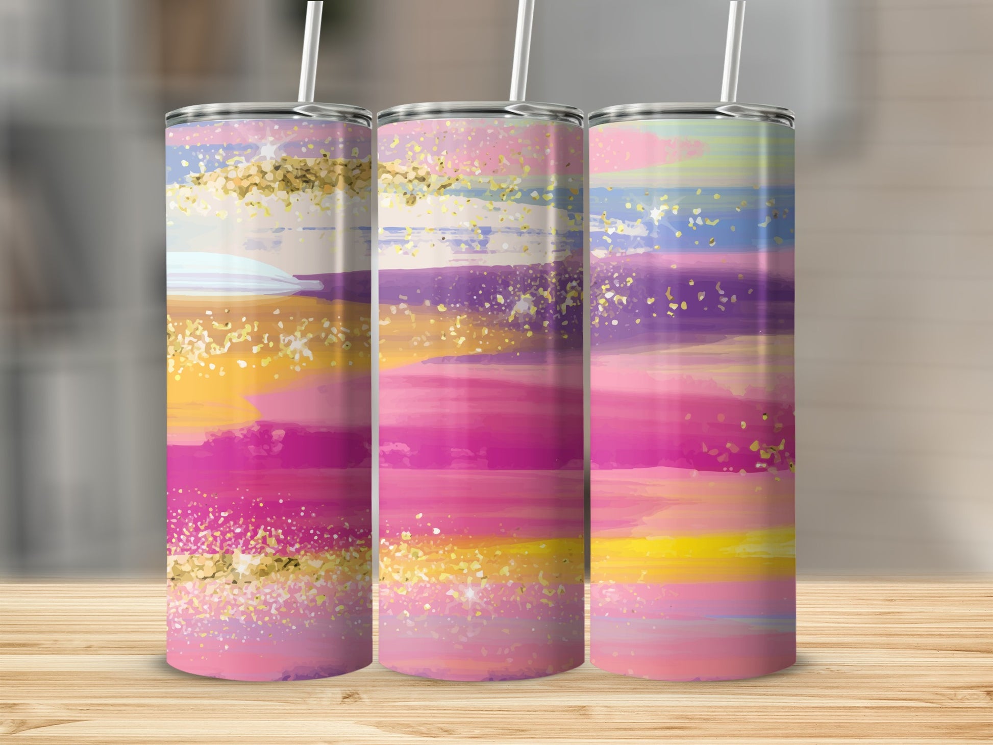 Three tumblers with colorful abstract brushstrokes and gold glitter accents.