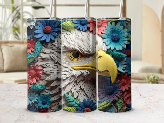 Eagle head with floral wreath design on a cylindrical tumbler.