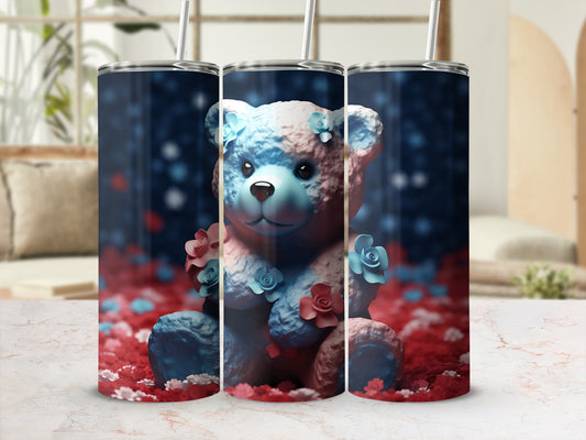 Blue and pink teddy bear with flowers on a white marble surface.