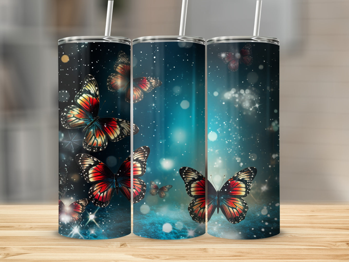 Three tumblers with bright red and black butterflies on a starry blue background.