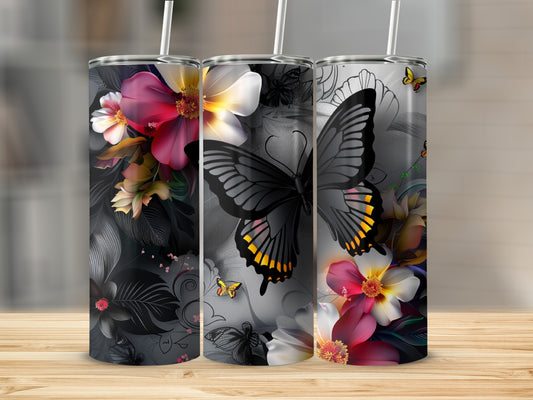 Three tumblers with butterflies and floral designs on a wooden surface.