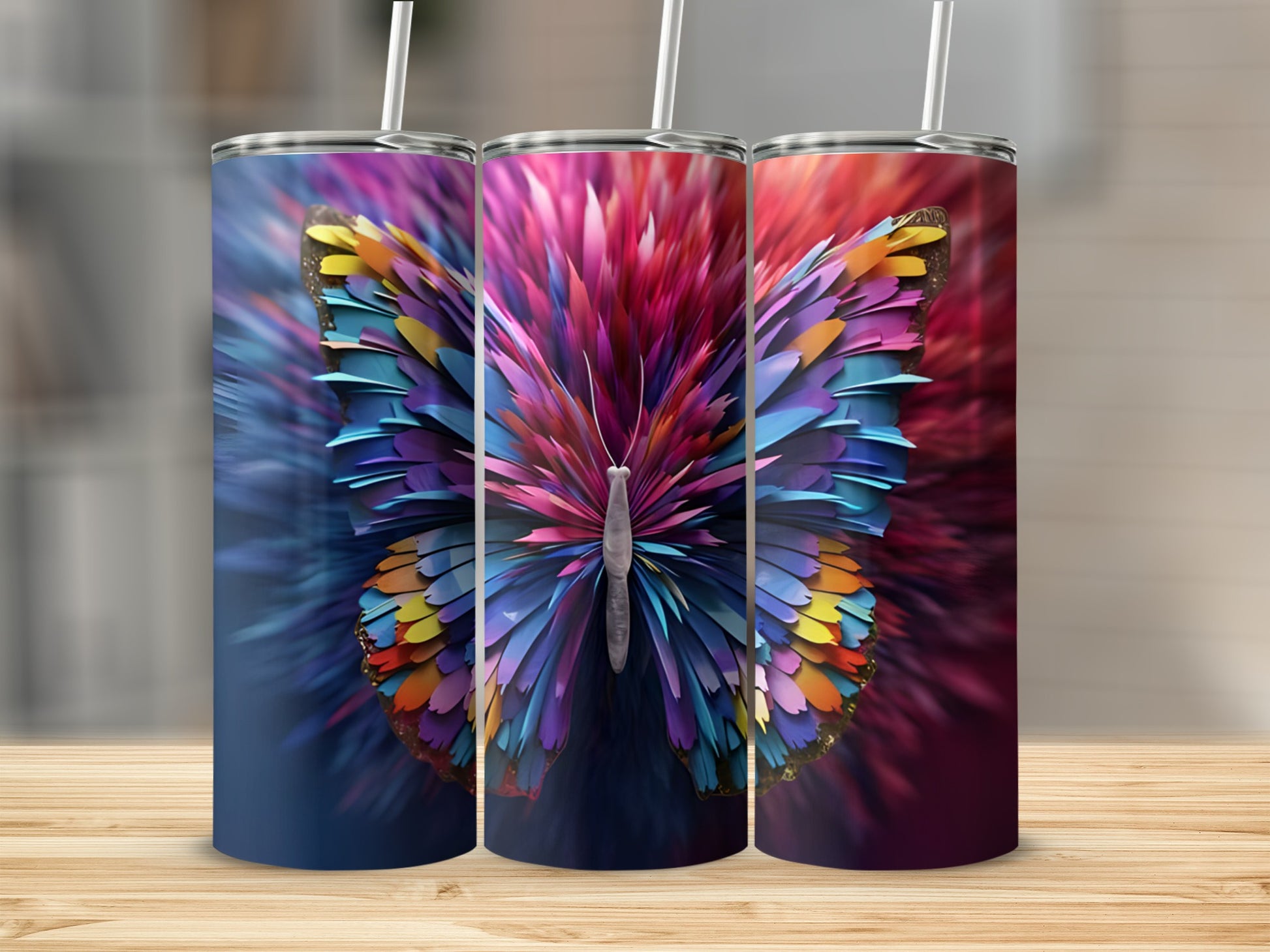 Three colorful butterfly tumblers with straw on a wooden surface.
