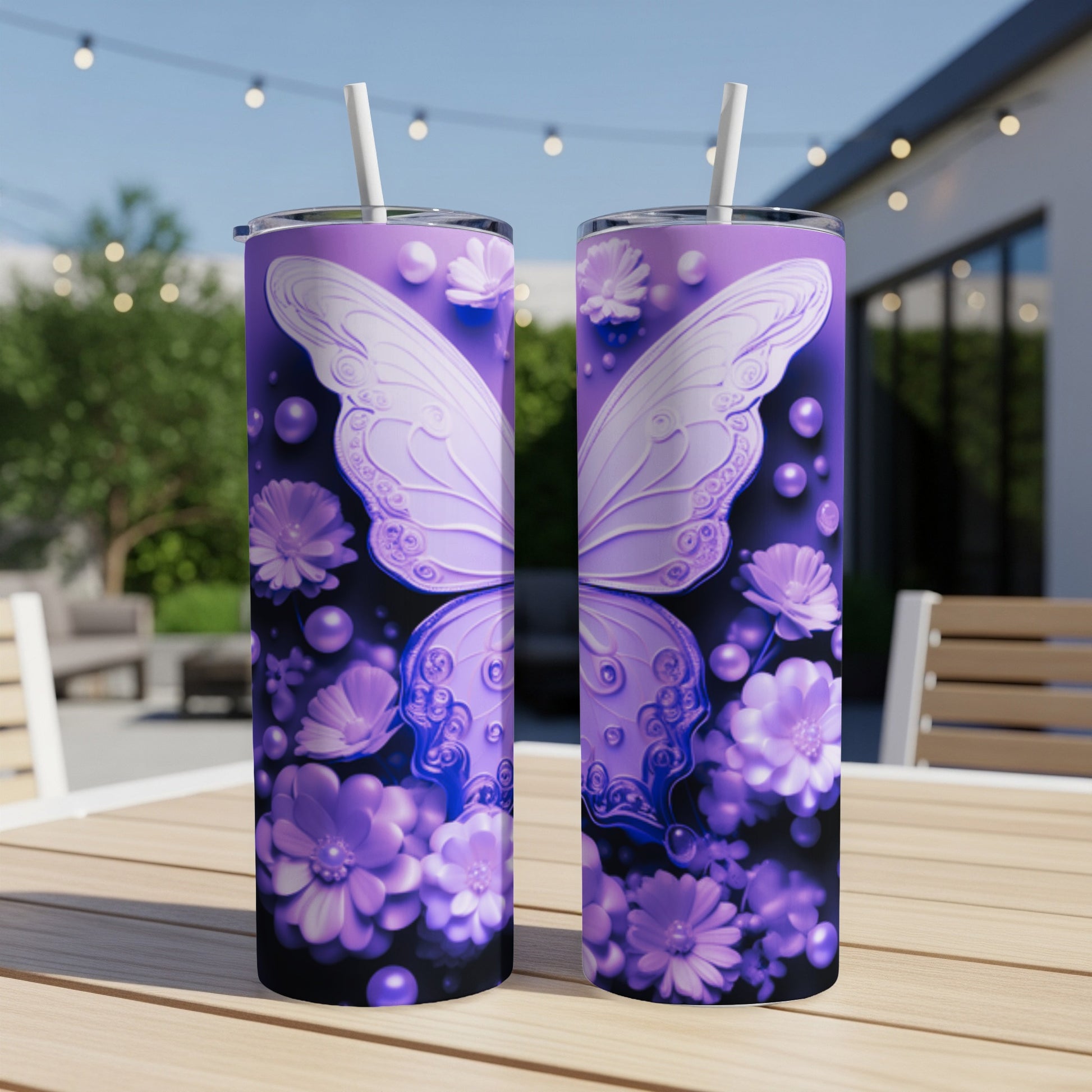 Two purple tumblers with butterfly wings and floral designs on a wooden table.