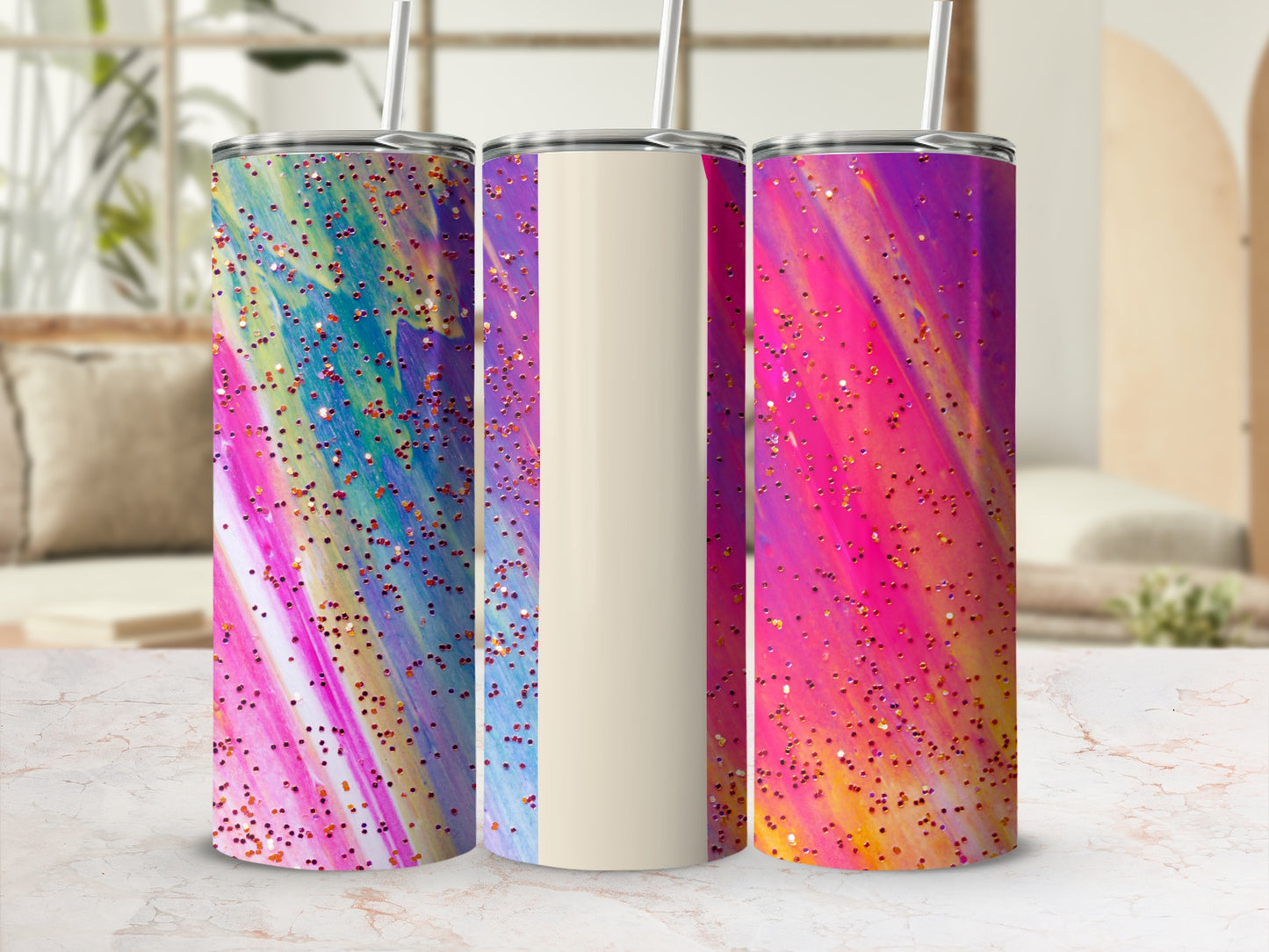 Three tumblers with colorful abstract patterns and glitter.