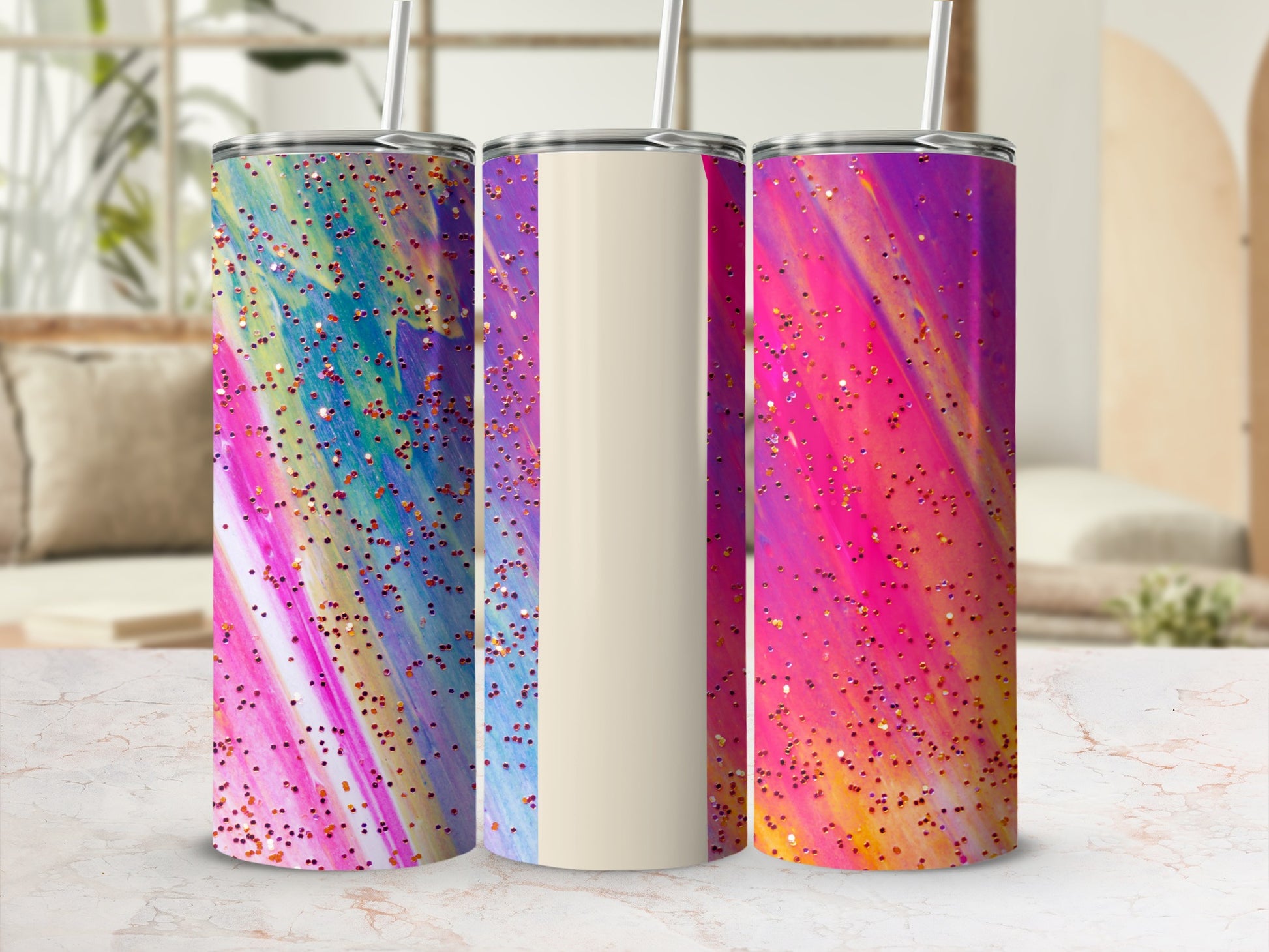 Three tumblers with colorful abstract patterns and glitter.