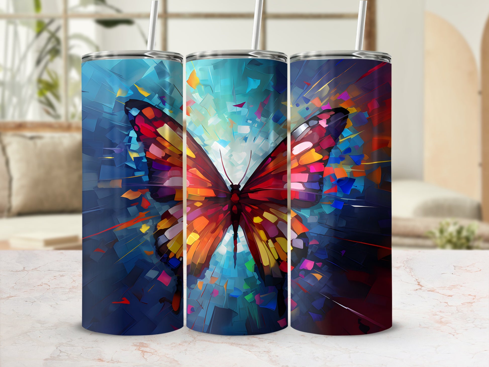 Abstract butterfly art on three tumblers with straws.