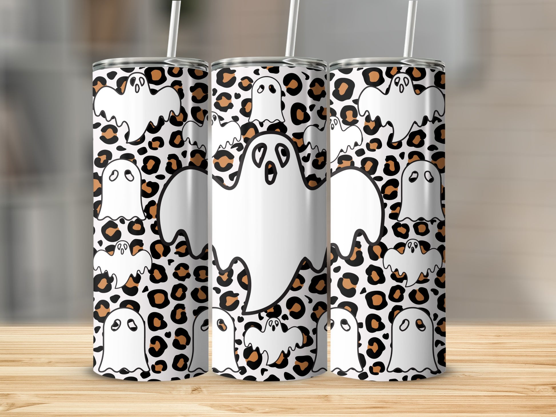 Three tumblers with a leopard print and cartoon ghost pattern.