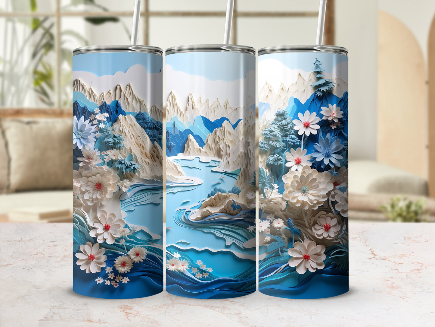 Three blue tumblers with a layered mountain and floral design.