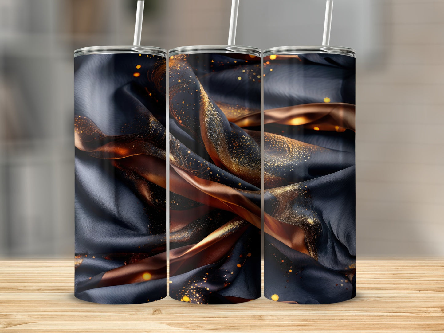 Dark blue and gold marbled tumbler with straw on a wooden surface.